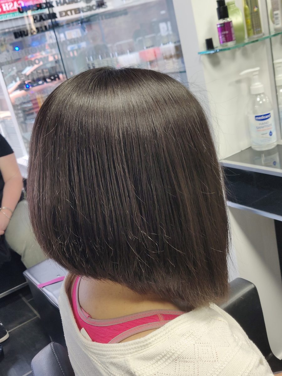 Glossy brunette blunt bob finished at Lux Studio Bow